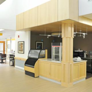 A modern and brightly lit cafe interior with a wooden counter.