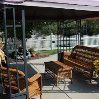 A cozy outdoor seating area under a gazebo, perfect for relaxation.