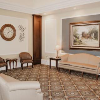 A cozy waiting room with elegant furniture and decor.