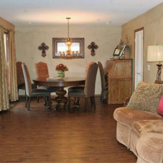Cozy living room with a wooden floor and a dining area.