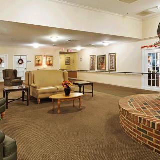 Comfortable lobby area with seating and brick accents.