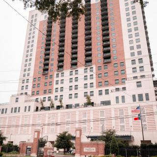 A tall urban high-rise building with a modern architectural design.