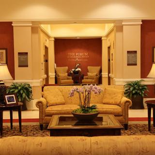 A warmly lit lobby with comfortable seating and elegant decor.