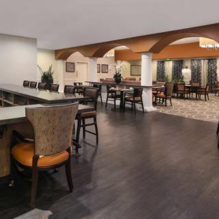A modern restaurant dining area with wooden flooring and stylish seating arrangements.