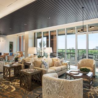 A modern living room with stylish furniture and large windows offering a scenic view.