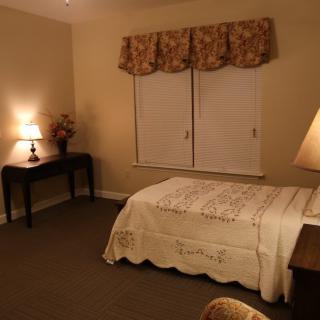 Cozy bedroom with warm lighting and elegant decor.