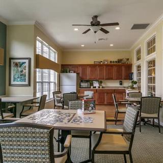 A spacious kitchen and dining area with modern furniture and appliances.