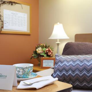 A cozy room with a comfortable bed, decorative elements, and a warm ambiance.