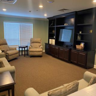 A cozy living room with recliners and a large entertainment center.