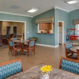A cozy community dining and living area with seating and decor.