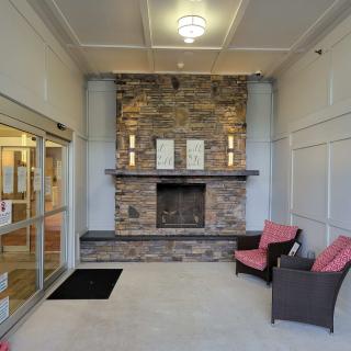 A welcoming lobby area featuring a stone fireplace and comfortable seating.