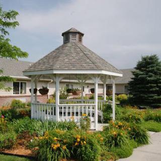 A charming gazebo surrounded by lush gardens and vibrant flowers.