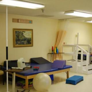 A well-equipped therapy room with exercise equipment for rehabilitation.