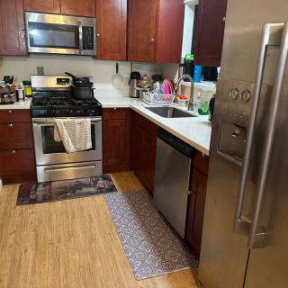 A modern kitchen with wooden cabinets and stainless steel appliances.
