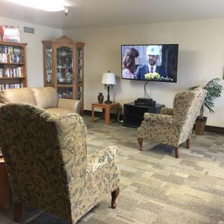 Cozy living room with chairs facing a television.