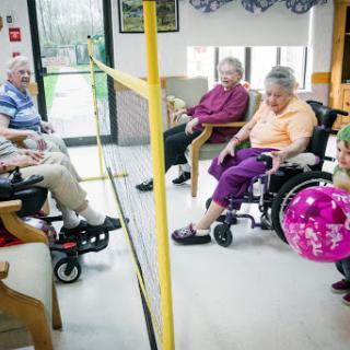 Seniors enjoying a game and socializing in a rehabilitation center.