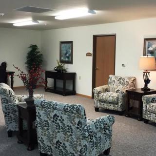 A cozy waiting room with floral patterned chairs and soft lighting.
