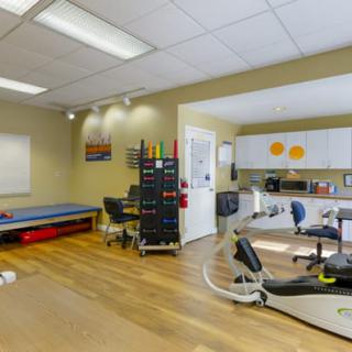 A clean and organized dental office with medical equipment and a treatment area.