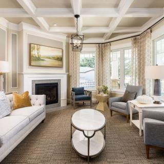 A modern and cozy living room with elegant furniture and a fireplace.