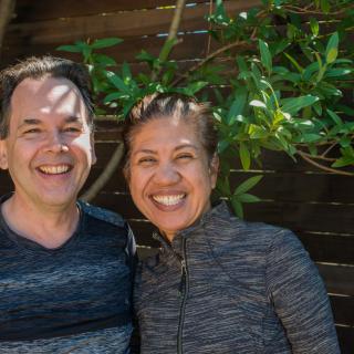 A smiling couple enjoying a sunny day outdoors.