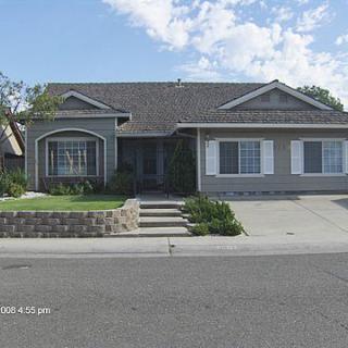 A suburban house with a neatly landscaped front yard.