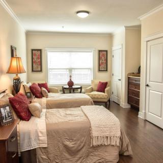 A cozy bedroom with twin beds, elegant decor, and a warm ambiance.