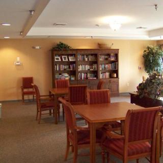 A cozy library interior with wooden furniture and bookshelves.