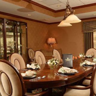 An elegantly decorated dining room with a set table and ambient lighting.
