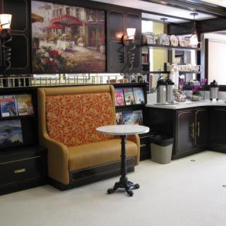 A cozy cafe interior with seating and a coffee station.
