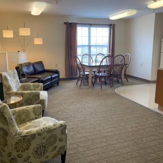 A cozy living and dining space featuring comfortable seating and a well-lit atmosphere.