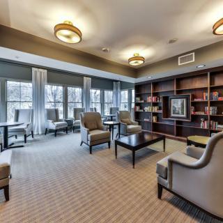 Cozy library lounge area with comfortable seating and ample natural light.