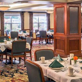 An elegant dining room with neatly arranged tables and chairs.
