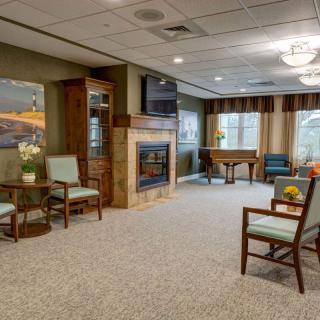 A cozy living room with comfortable seating, a fireplace, and a television.
