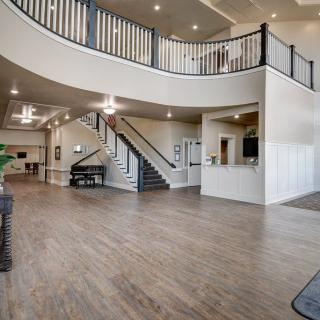 A modern lobby with an open floor plan and a central staircase.