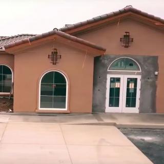 A single-story building with arched windows and a tiled roof.