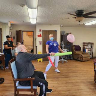Residents and staff engage in a fun activity, promoting movement and social interaction.
