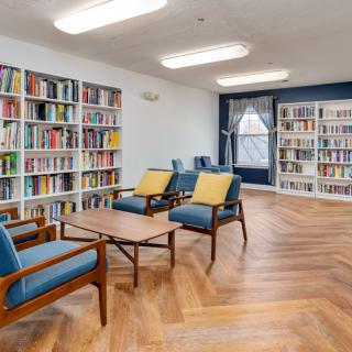 A modern library with comfortable seating and well-organized bookshelves.