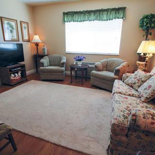 A cozy living room with comfortable seating and warm lighting.