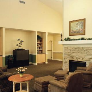 A cozy living room with a fireplace and comfortable seating.