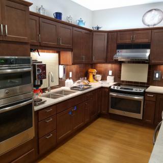 A modern kitchen with wooden cabinets and stainless steel appliances.