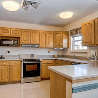 A traditional kitchen with wooden cabinets and modern appliances.