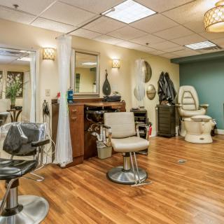 A well-equipped hair salon interior with chairs, mirrors, and modern decor.