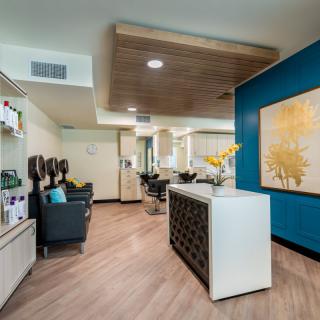 Modern salon interior with a cozy waiting area and stylish decor.
