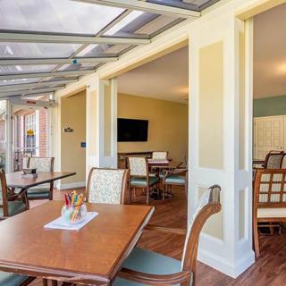 A bright and open indoor dining area featuring elegant tables and chairs.
