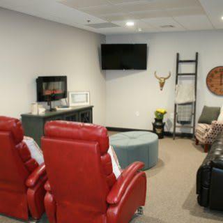 A cozy home theater setup with red recliners and modern decor.