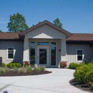 A modern building with a welcoming entrance, surrounded by well-maintained landscaping.