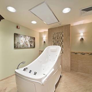 A luxurious spa room featuring a sleek bathtub designed for ultimate relaxation.