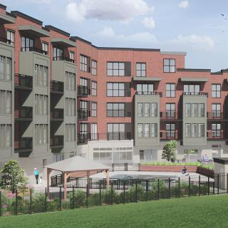 A modern apartment complex featuring balconies and a landscaped outdoor area.