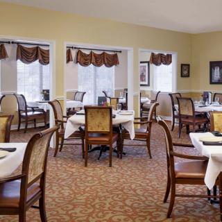 An elegant dining room with neatly arranged tables and chairs, ready for guests.