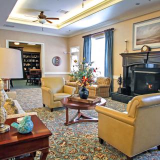 A cozy living room with elegant decor, featuring a fireplace and comfortable seating.
